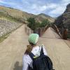 Student looking at two different paths on a trail.