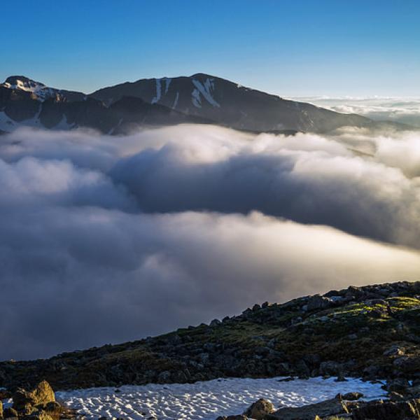 Clouds settle in the valley below