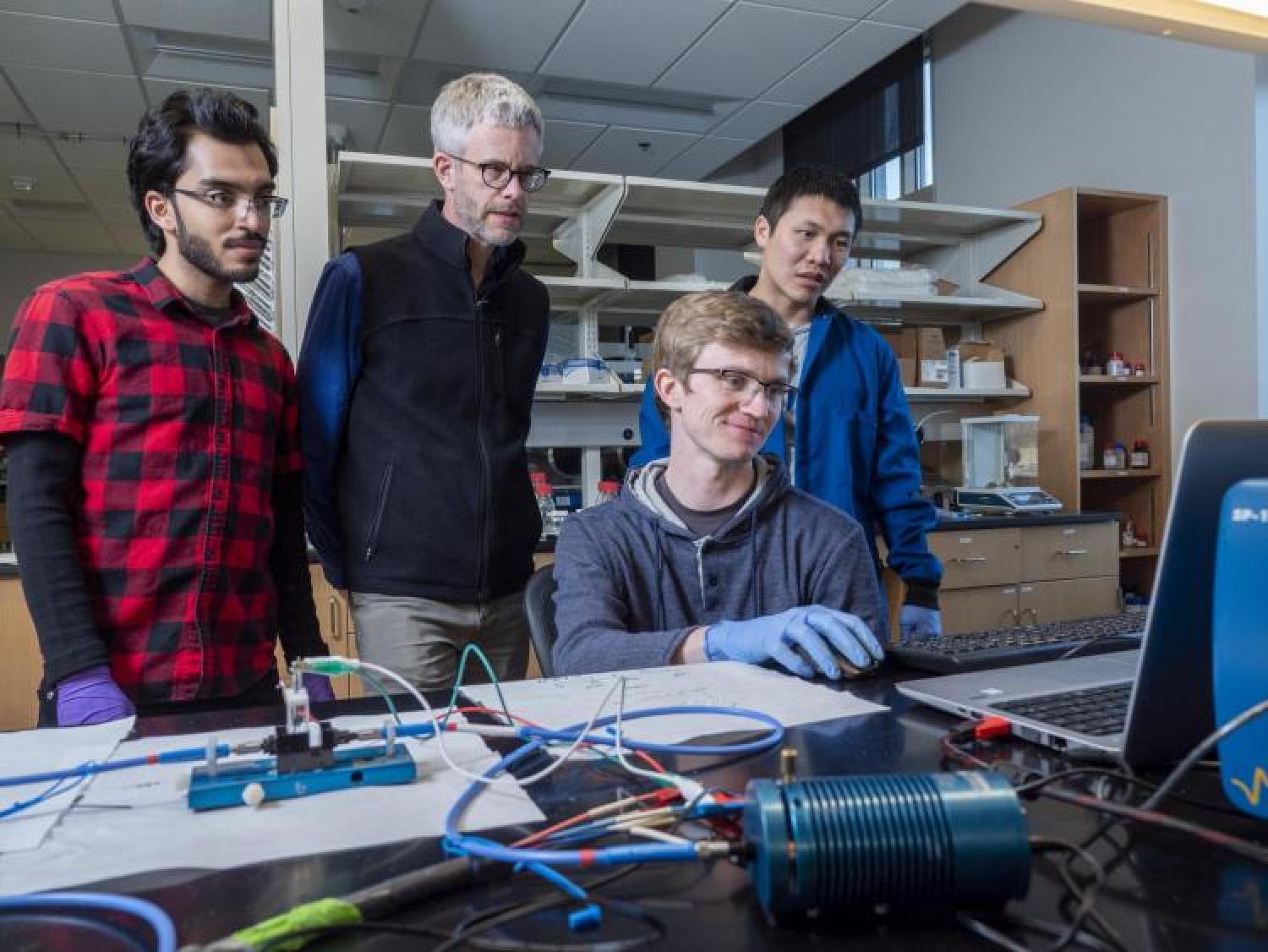 Professor Mike McGehee and students working in the lab