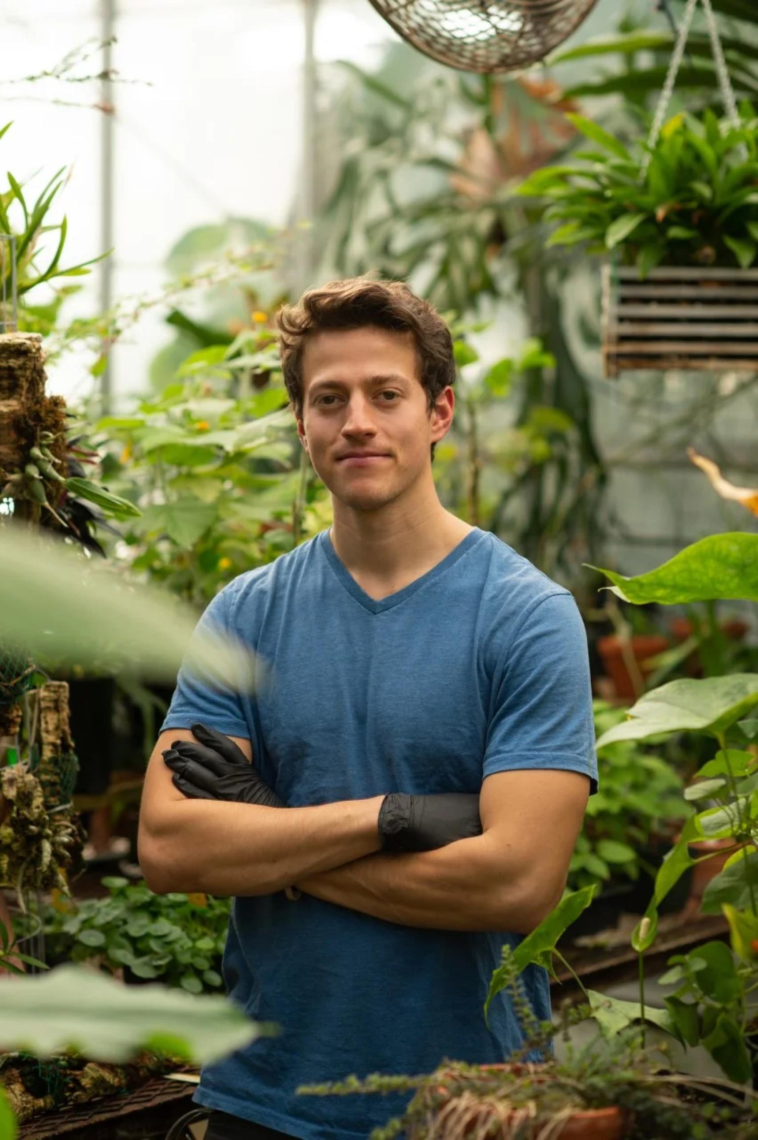 Elliot Strand in a greenhouse.