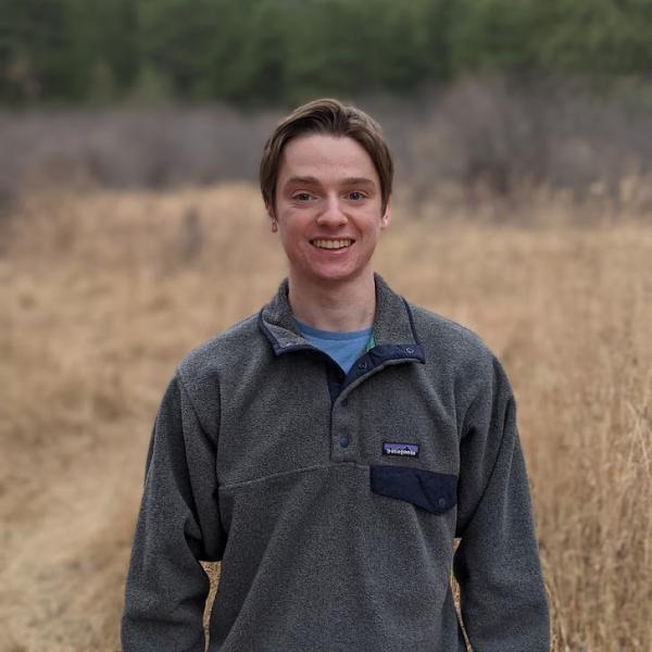 Gabe McAndrews with mountains in background