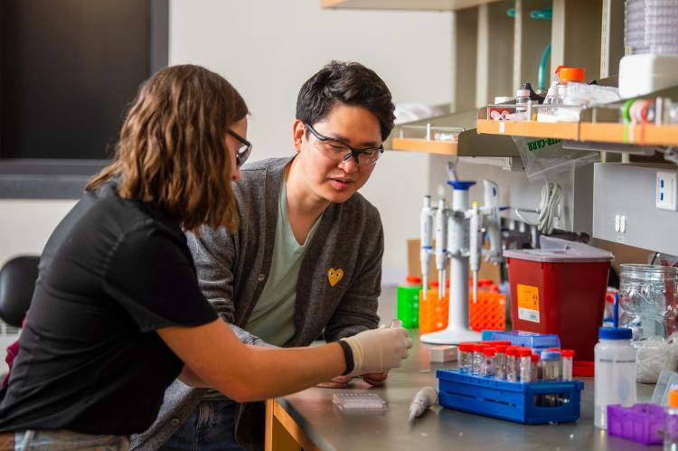 Two students working in a lab.