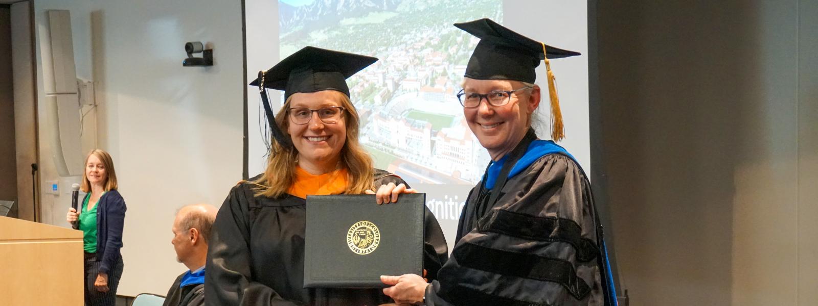 A student shaking Stephanie Bryant's hand.
