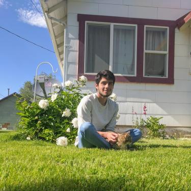 Omar Lewis sitting on a lawn