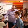 A faculty member working with two students in a lab.