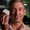 Wil Srubar with a small algae-grown concrete block.