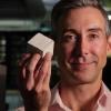 Wil Srubar with a small algae-grown concrete block.