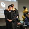 A student being hooded.