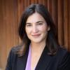 Tanja Cuk in black suit jacket and purple shirt