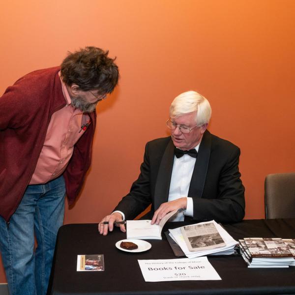 Tom Riis signing his book