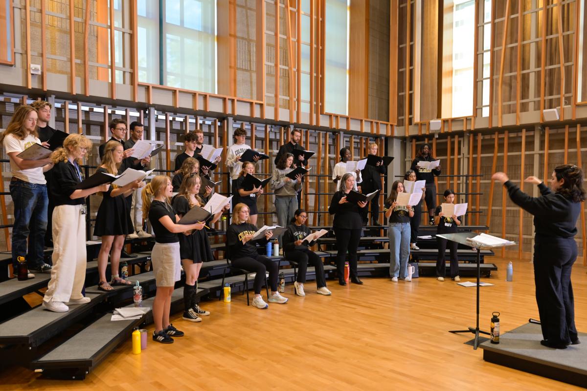 Undergraduate music education student conducting choir