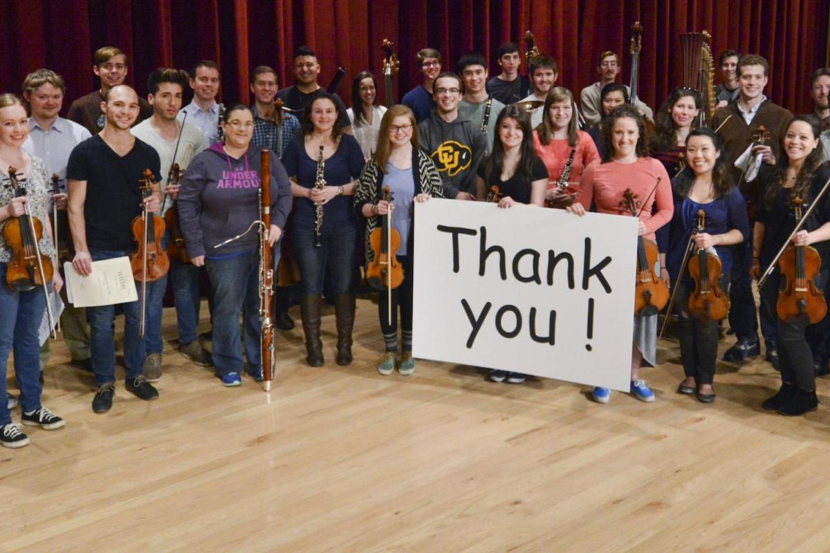 students holding instruments and thank you sign