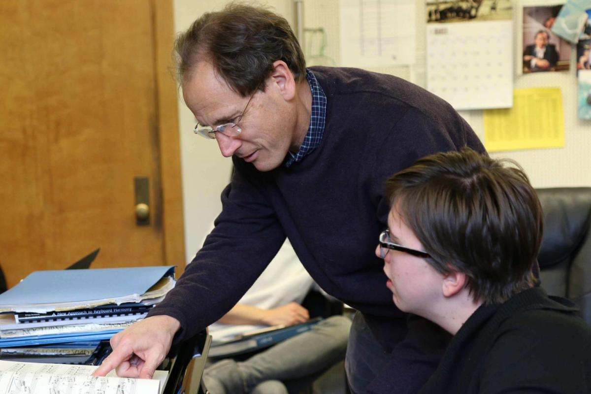 piano teacher and student during a lesson