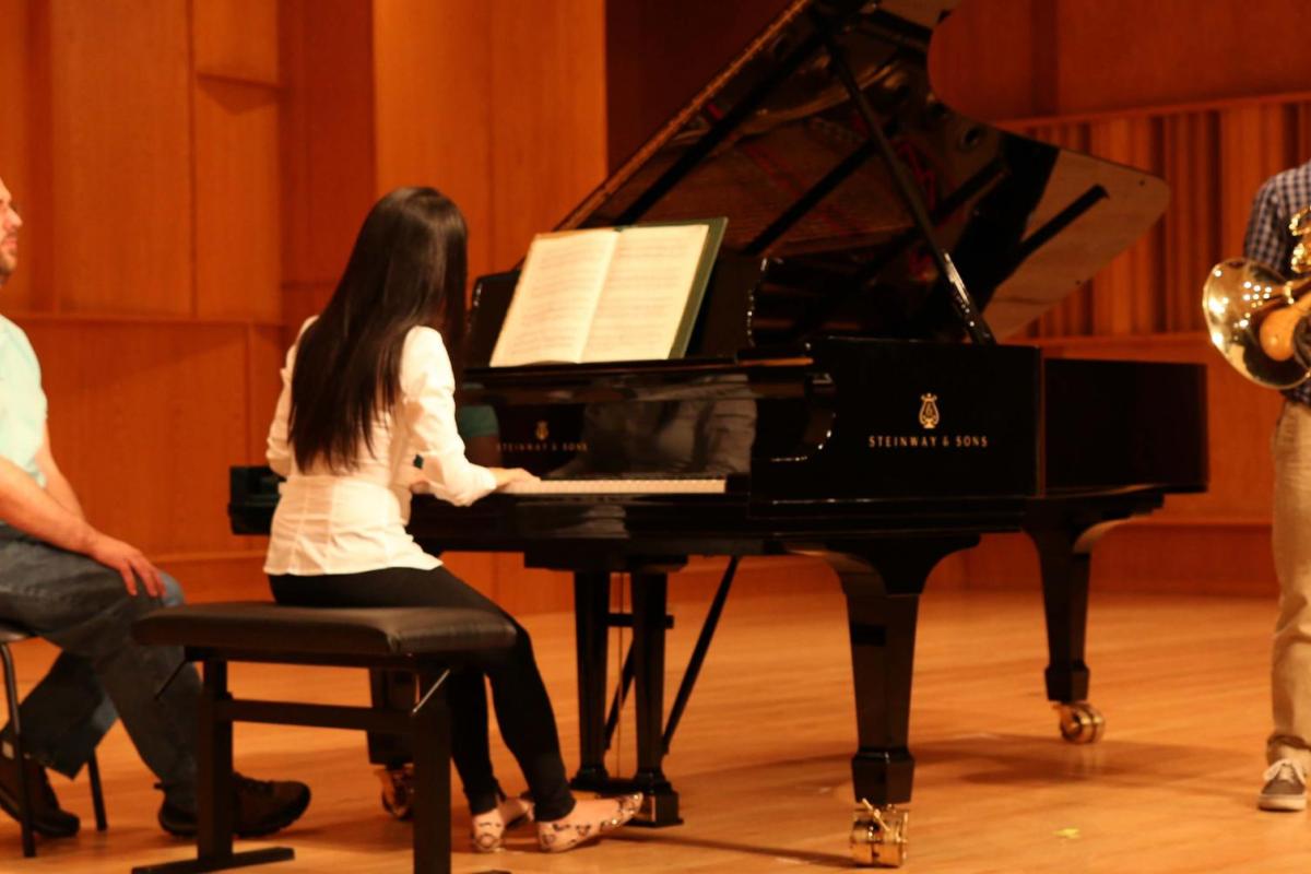 pianist on stage working with a horn player