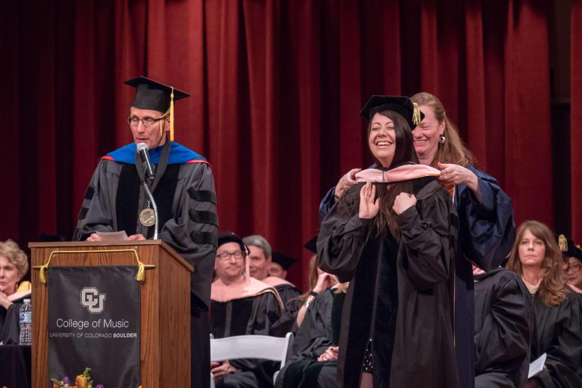 Student graduating at Grusin
