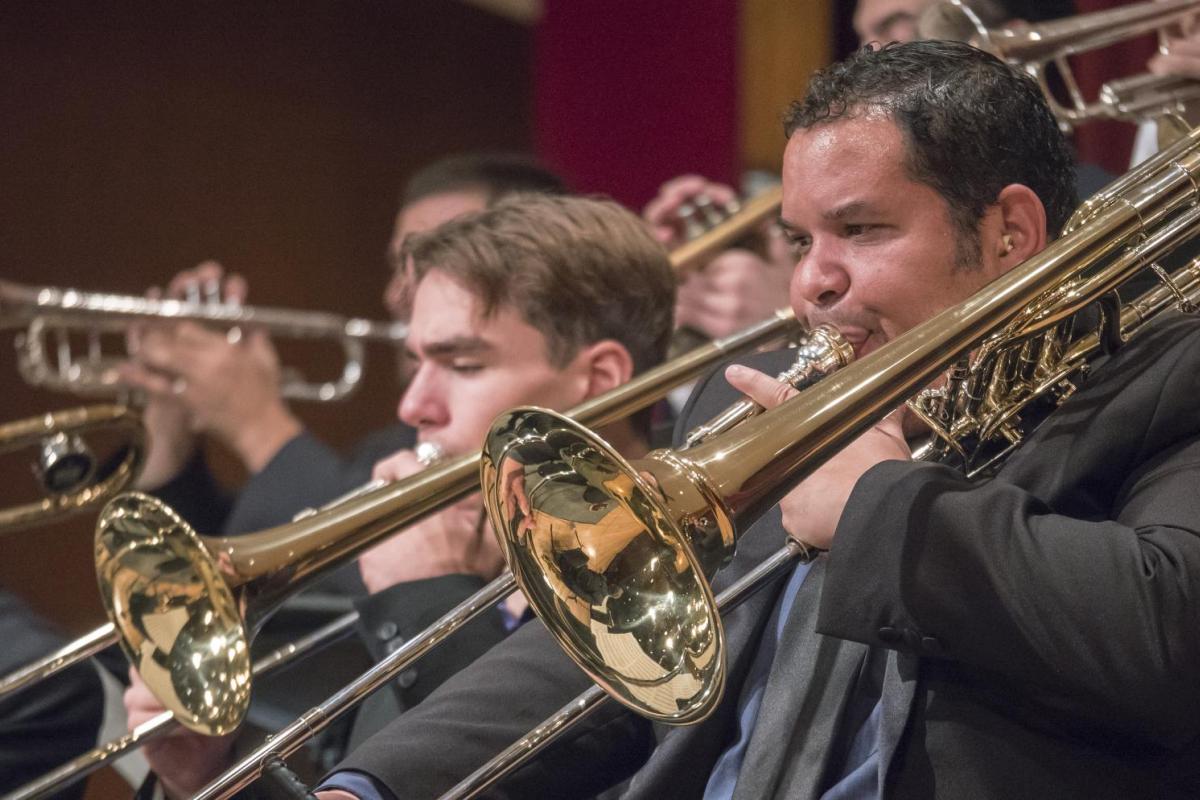 student plays trombone in concert