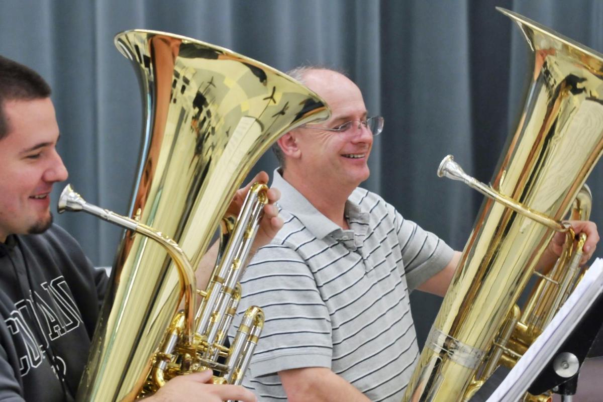 student and faculty member playing tuba