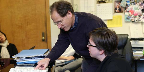 student and teacher at piano