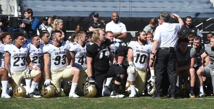 group of football players in a huddle
