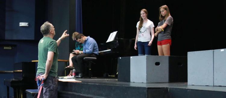 Students rehearse on stage