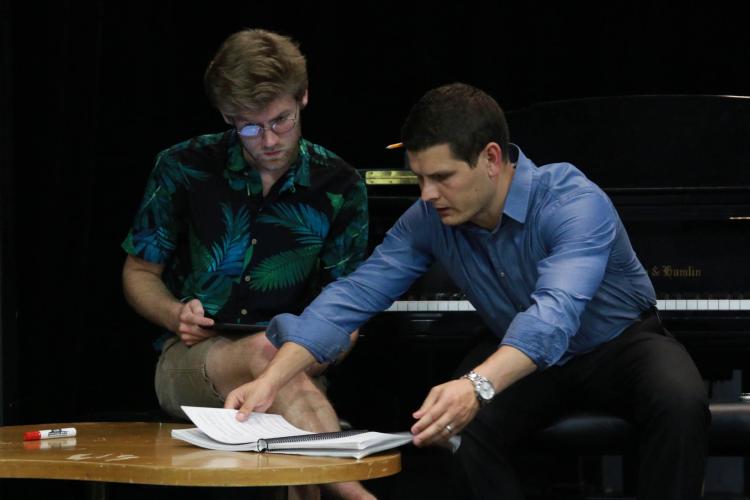pianists look over music