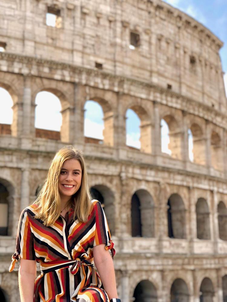 Allison Cawthon smiling in front of the Colosseum