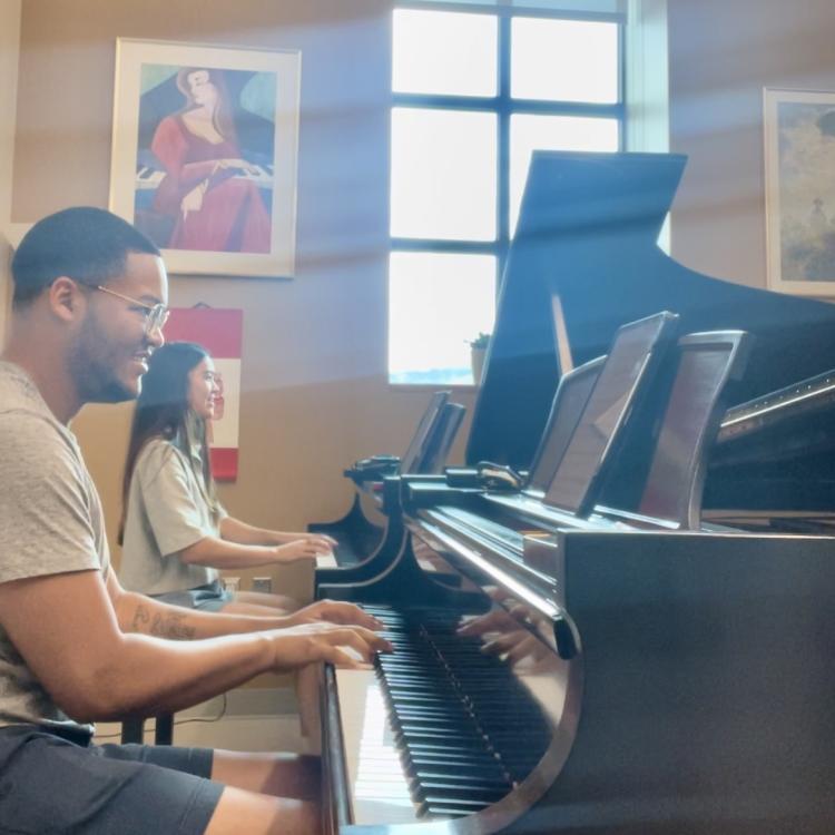 Abigail Terrill (MM ’24) and duo partner James Morris (DMA ’25) rehearse his first piano duo composition that premiered last year. Terrill is playing an alternatively sized keyboard on loan at the CU Boulder College of Music.