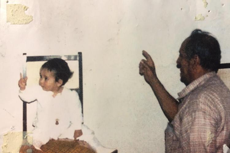 A young Julieta García and her grandfather watch an orchestra performance on television in her hometown of Jacona, Mexico.