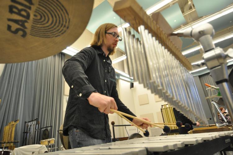 A student using four mallets on the vibraphone