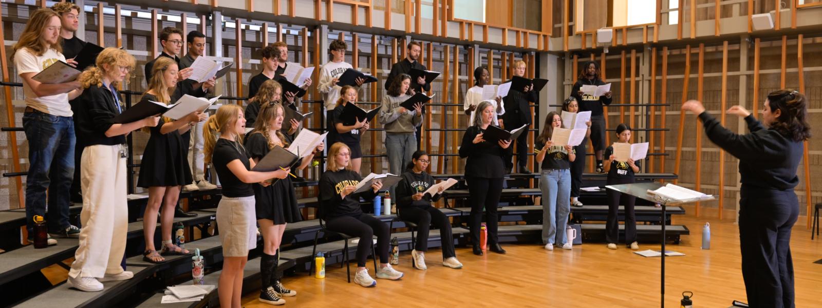 Music education student conducting choir