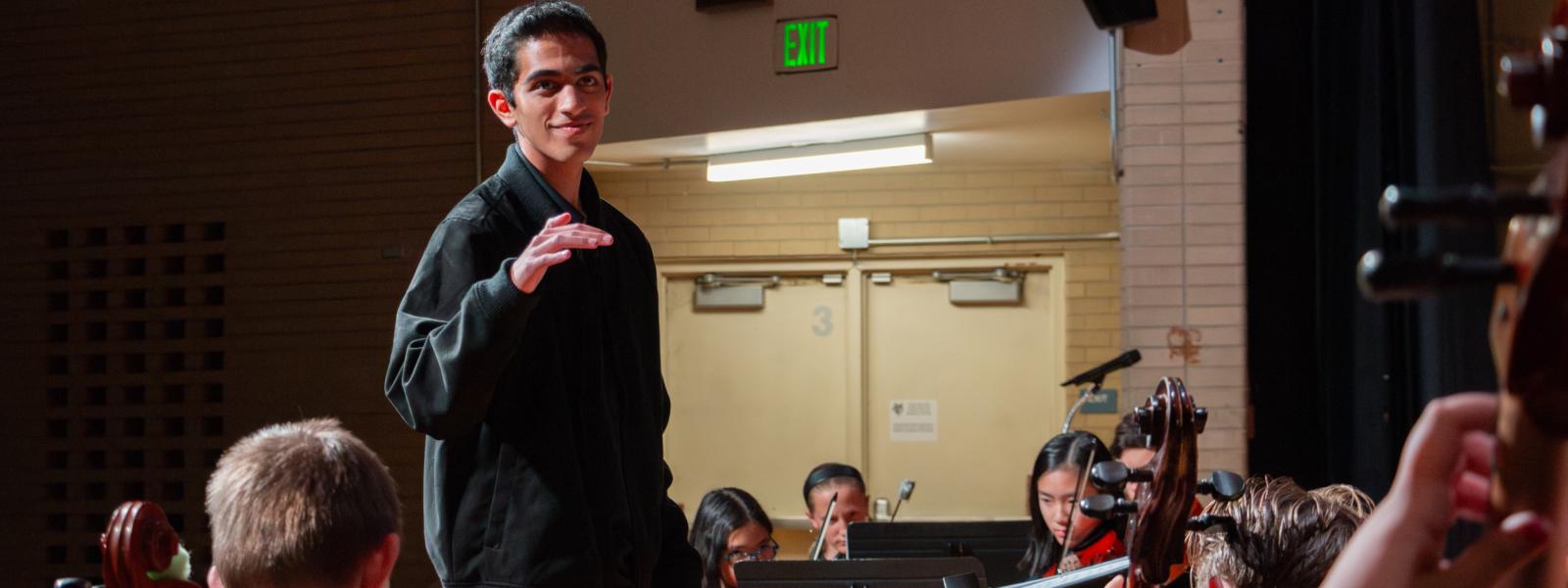 Music education student conducting orchestra