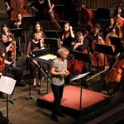 Jamie Bernstein on stage with the CU Symphony