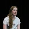 student rehearses on stage