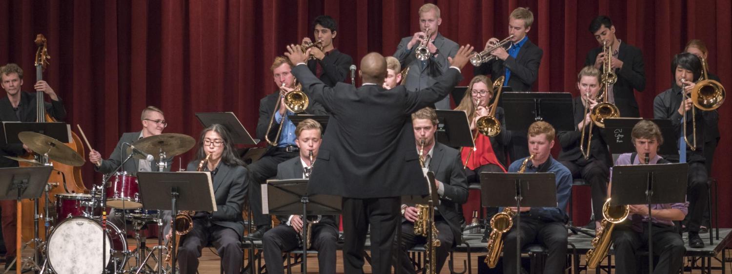 Jazz ensemble students following conductor