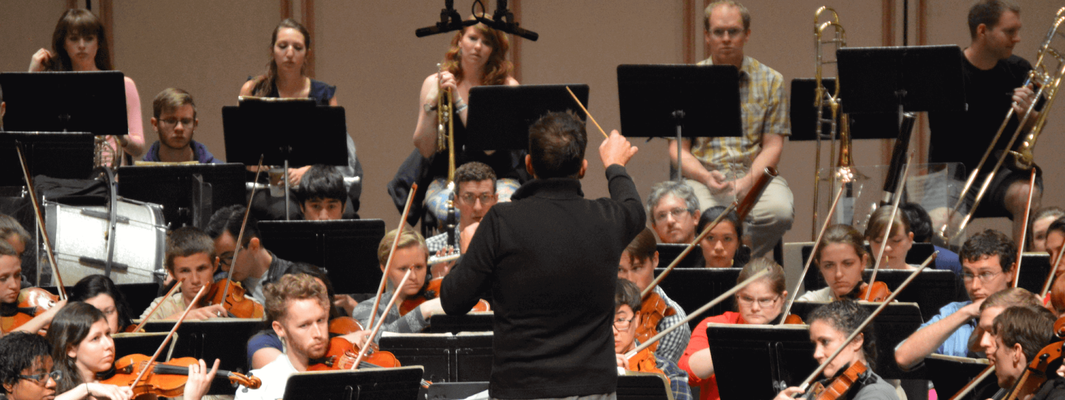 Students following conductor in rehearsal
