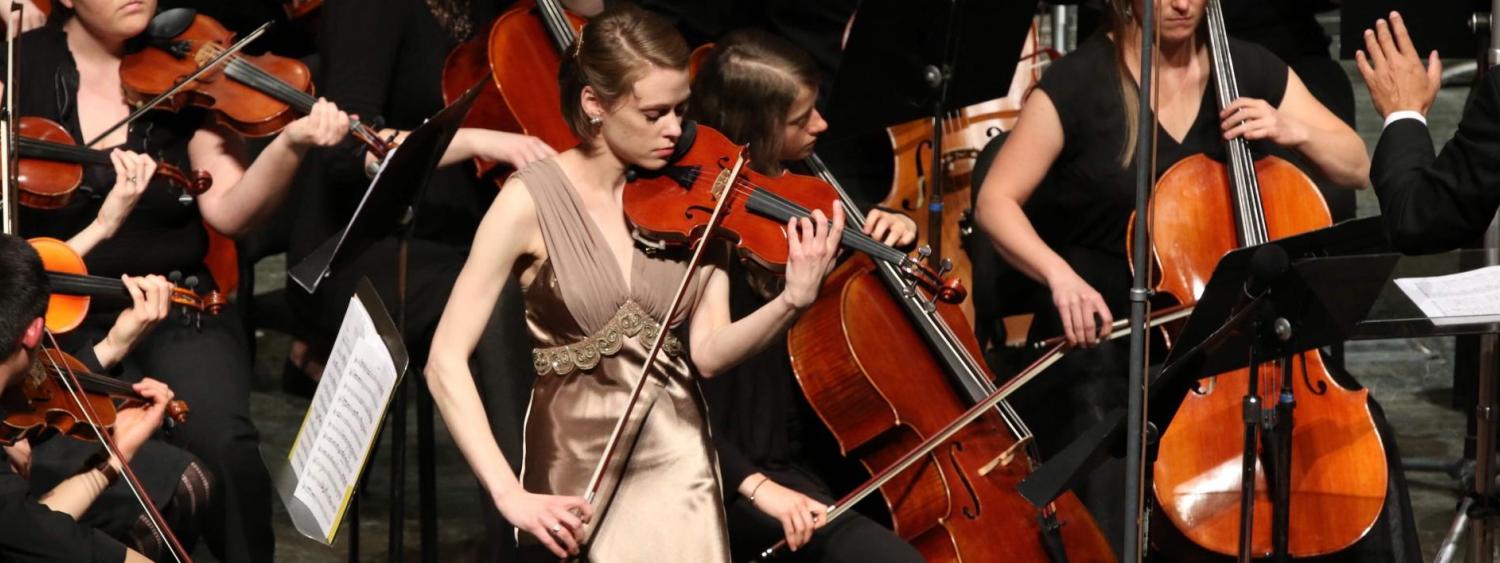 Violinist performing with orchestra