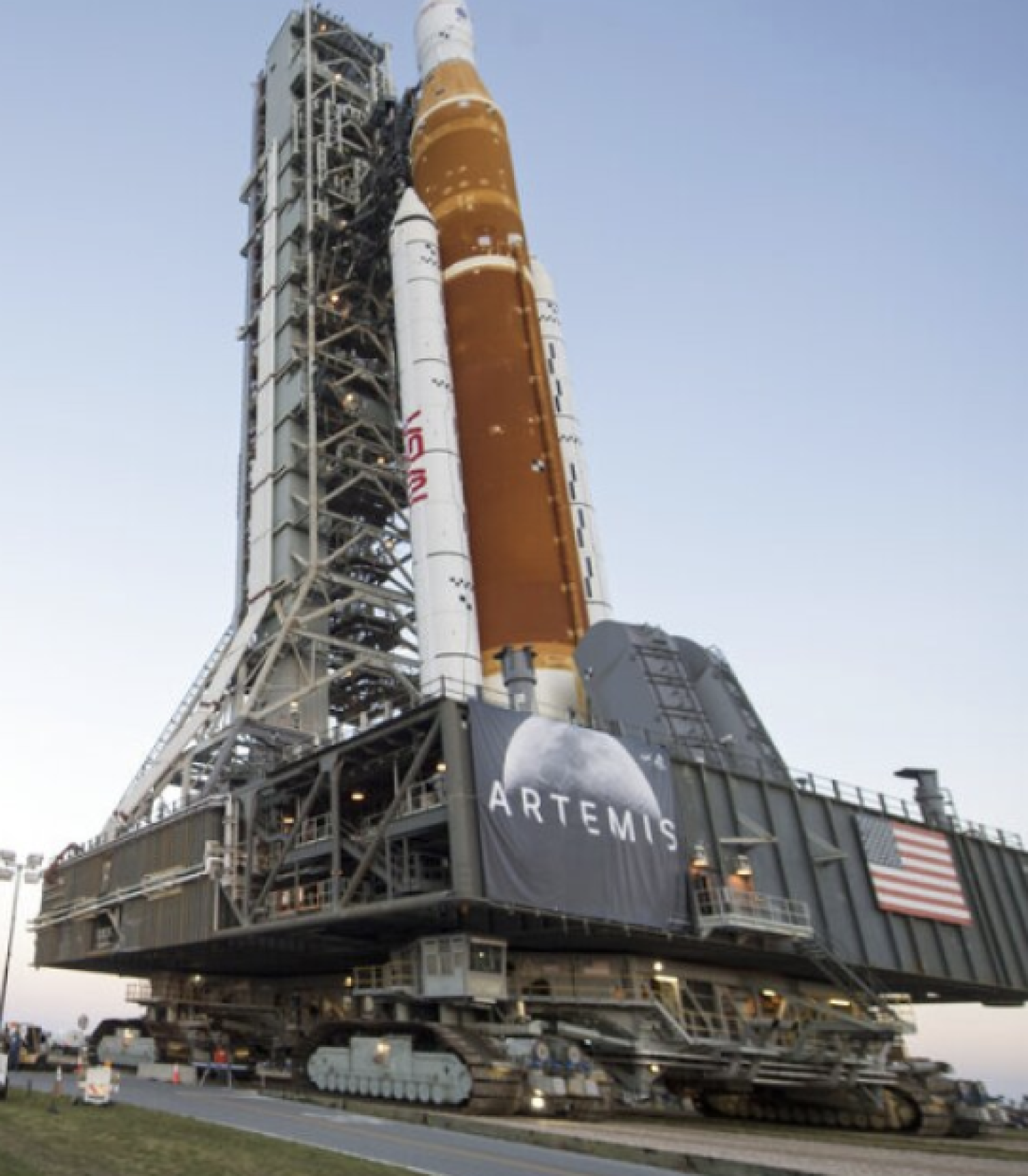 NASA employees take photos as NASA's Space Launch System (SLS) rocket with the Orion spacecraft aboard is rolled out of High Bay 3 of the Vehicle Assembly Building for the first time, at the Kennedy Space Center in Cape Canaveral, Fla.