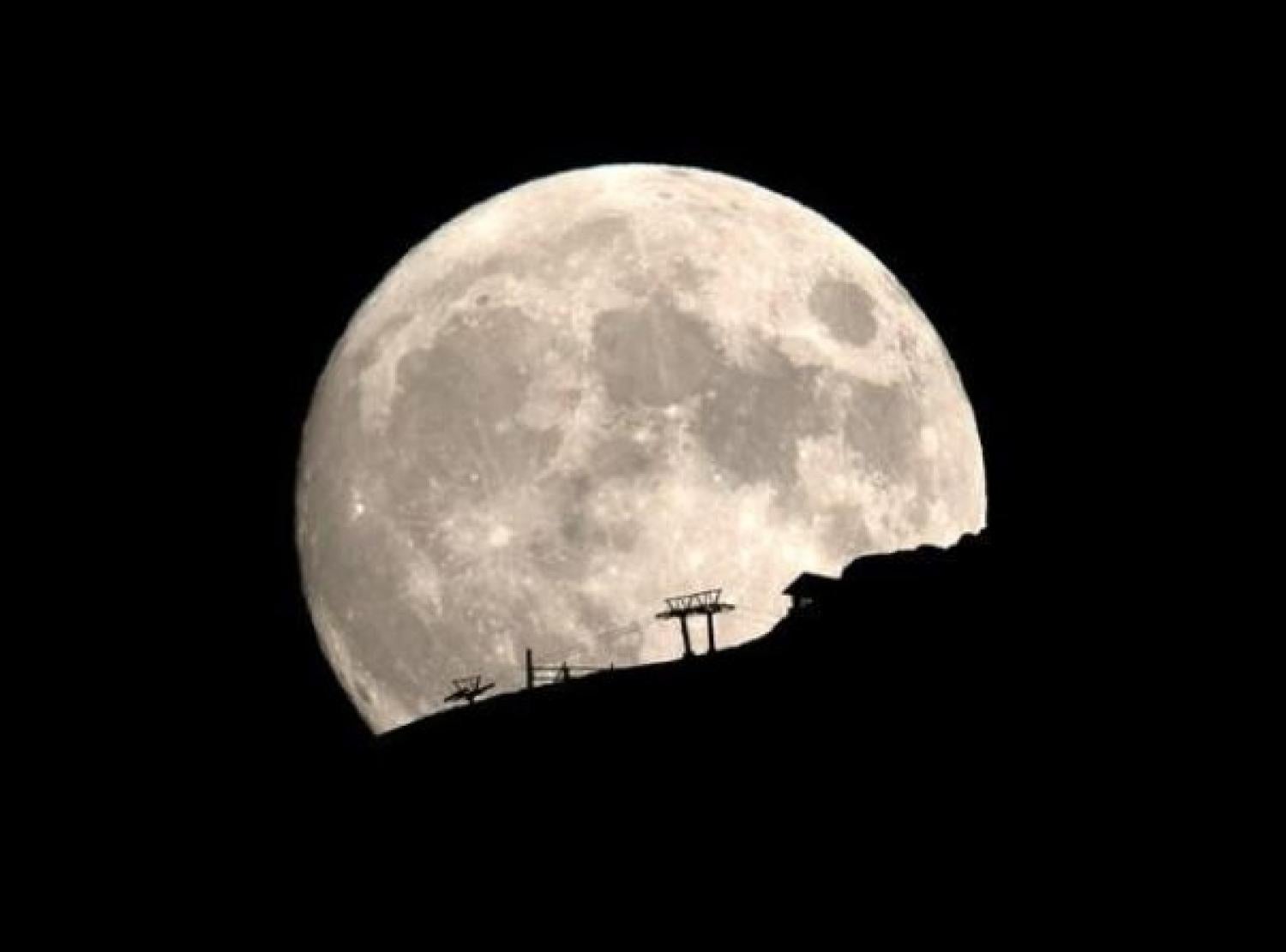 The moon rises near the town of Kalavrita, Greece, August 14, 2019 REUTERS Alkis Konstantinidis