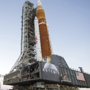 NASA employees take photos as NASA's Space Launch System (SLS) rocket with the Orion spacecraft aboard is rolled out of High Bay 3 of the Vehicle Assembly Building for the first time, at the Kennedy Space Center in Cape Canaveral, Fla.