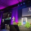 Photo of Jack Burns on stage giving a talk at the AAS meeting