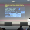 Screen shot from conference room with Jack Burns's slide on the screen