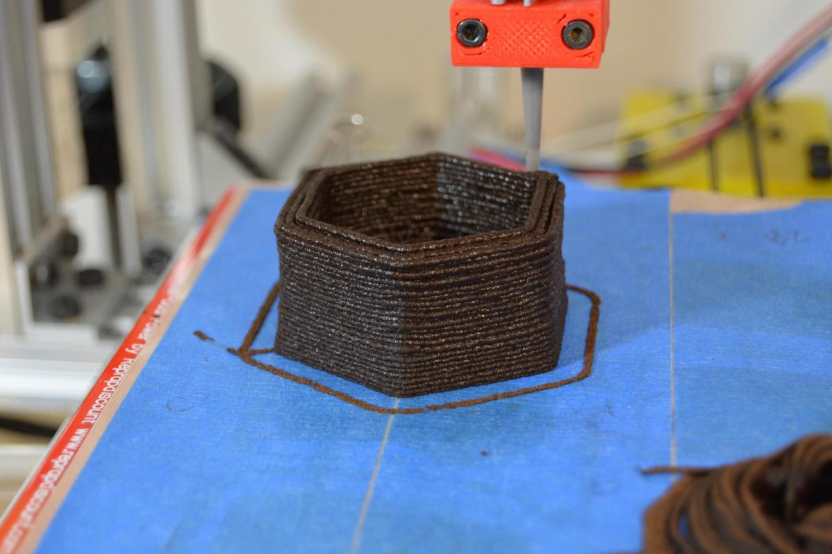 3D printing tip places layers of brown paste