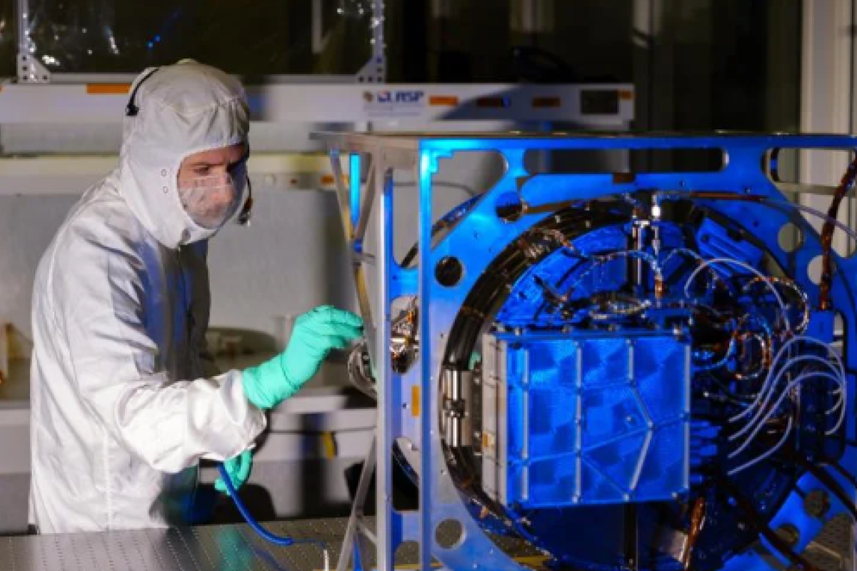 Engineer inspects the Interstellar Dust Experiment (IDEX) instrument.
