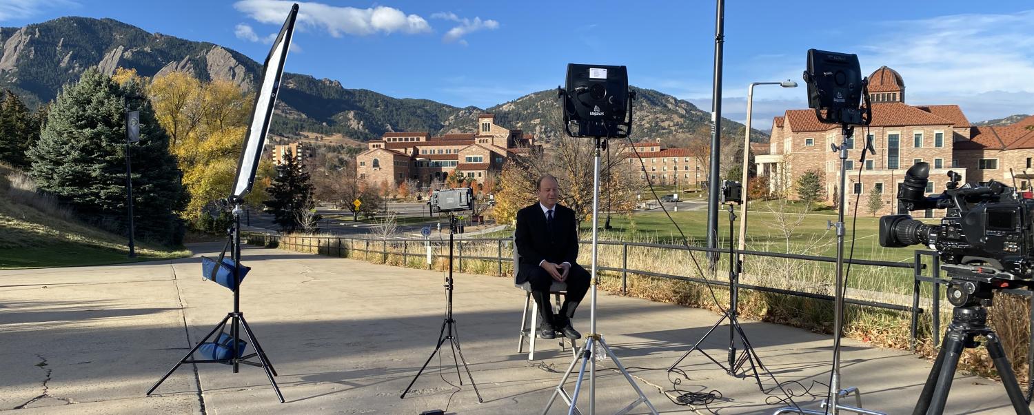 Governor Jared Polis being interviewed on campus.