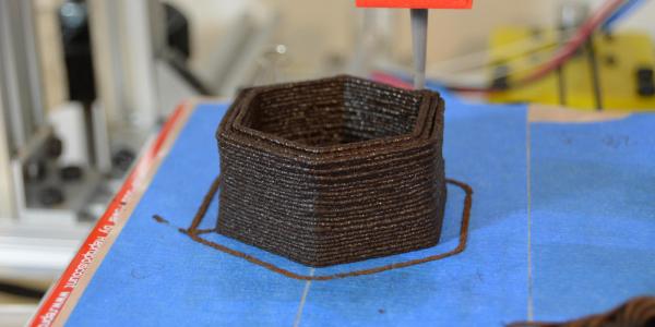 3D printing tip places layers of brown paste
