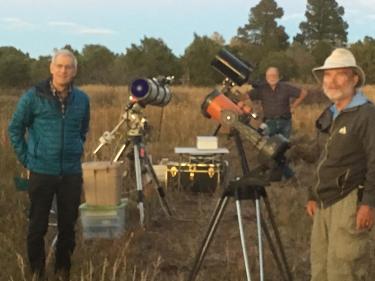 Astronomers taking pictures and using several telescopes