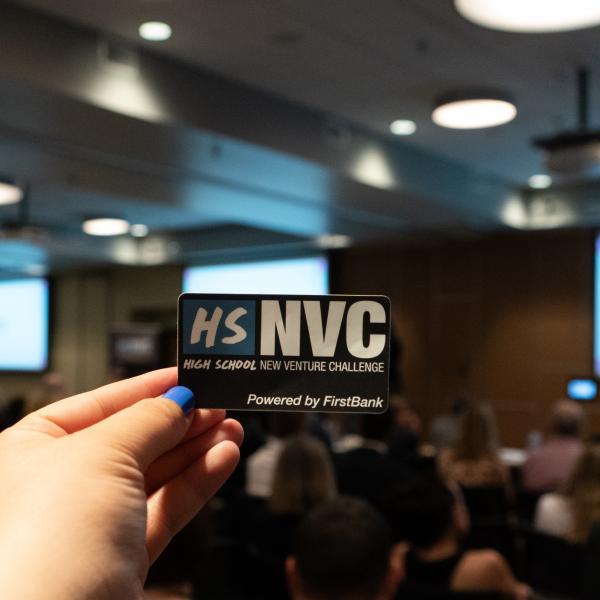 Hand holding HSNVC sticker