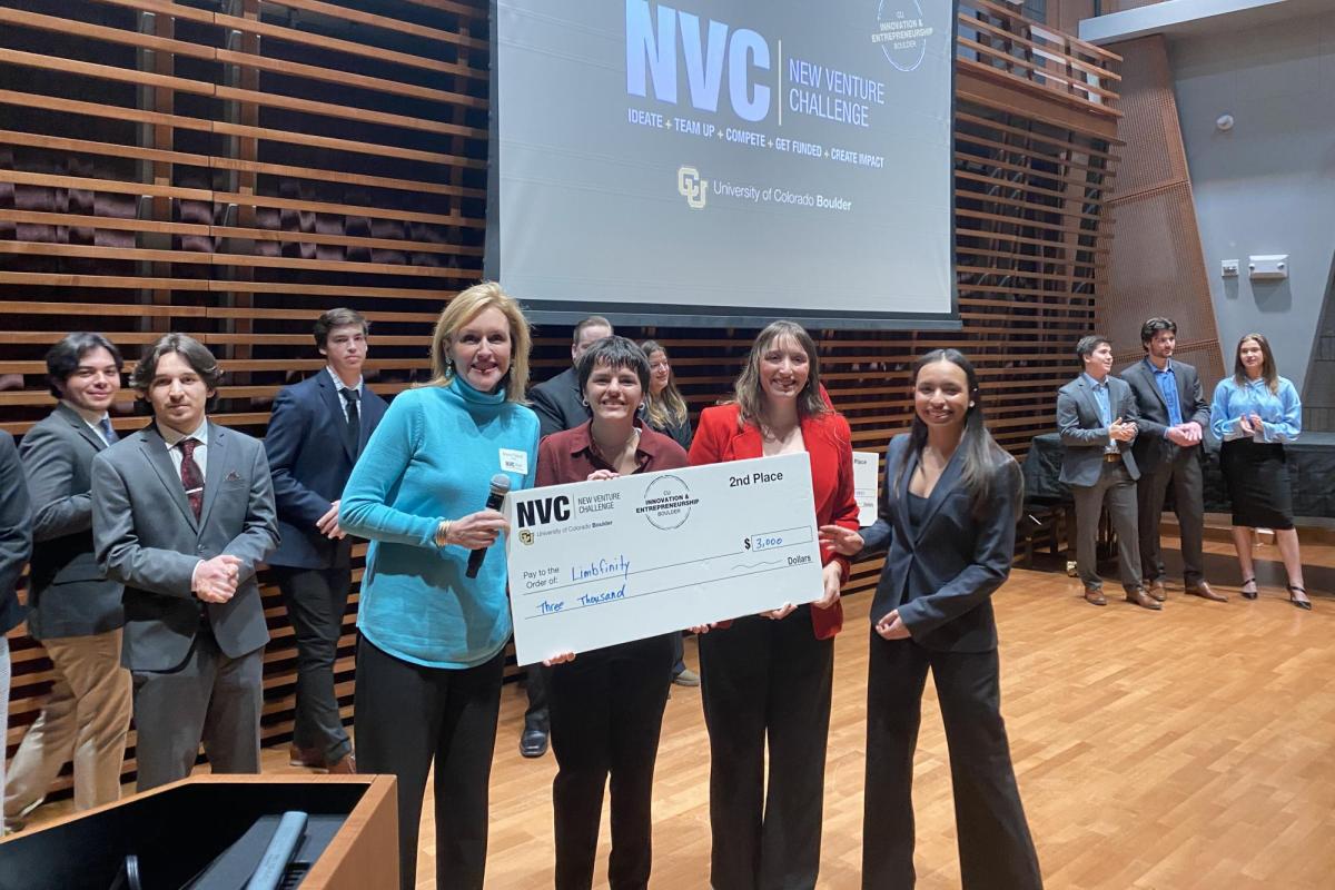 Winners hold up prize check