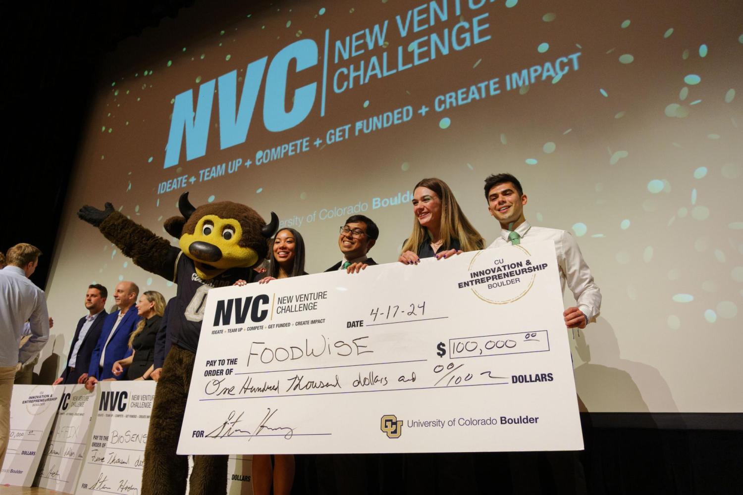 Team poses with giant prize-winning check and the CU Boulder mascot Chip.