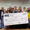 Team stands with giant prize check